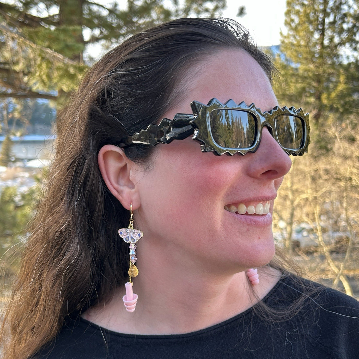 girl wearing pink earplug earrings