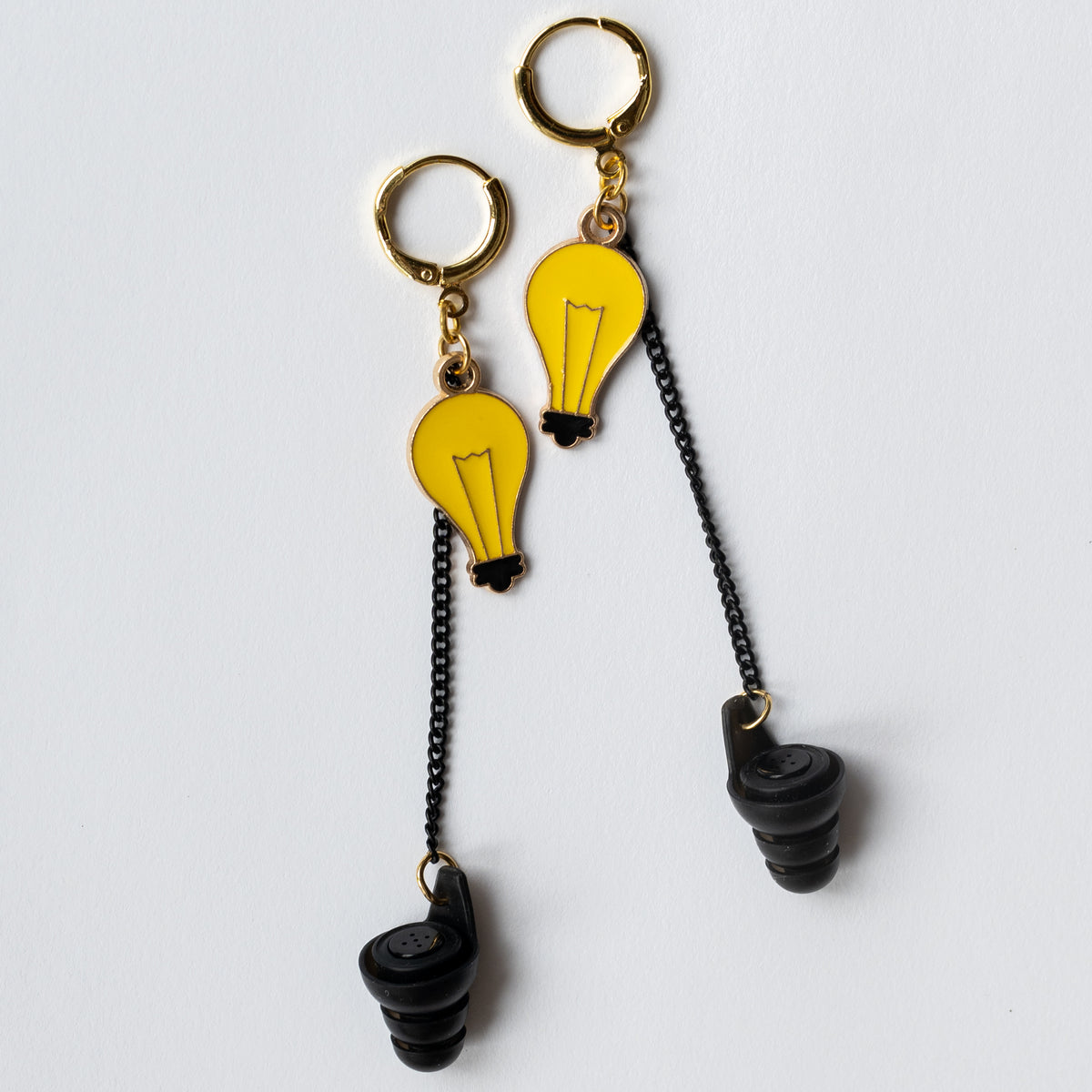 Lightbulb charm noise reducing earplug earring for educators managing noisy classroom environments