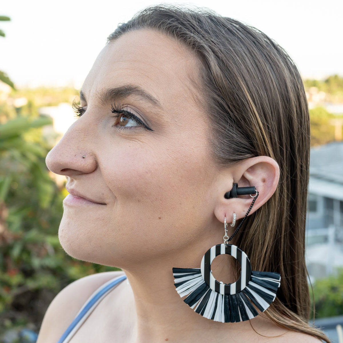 chic earplug earrings for concerts on French girl